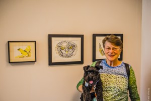 Jane Knodell enjoys the artwork with her furry companion.